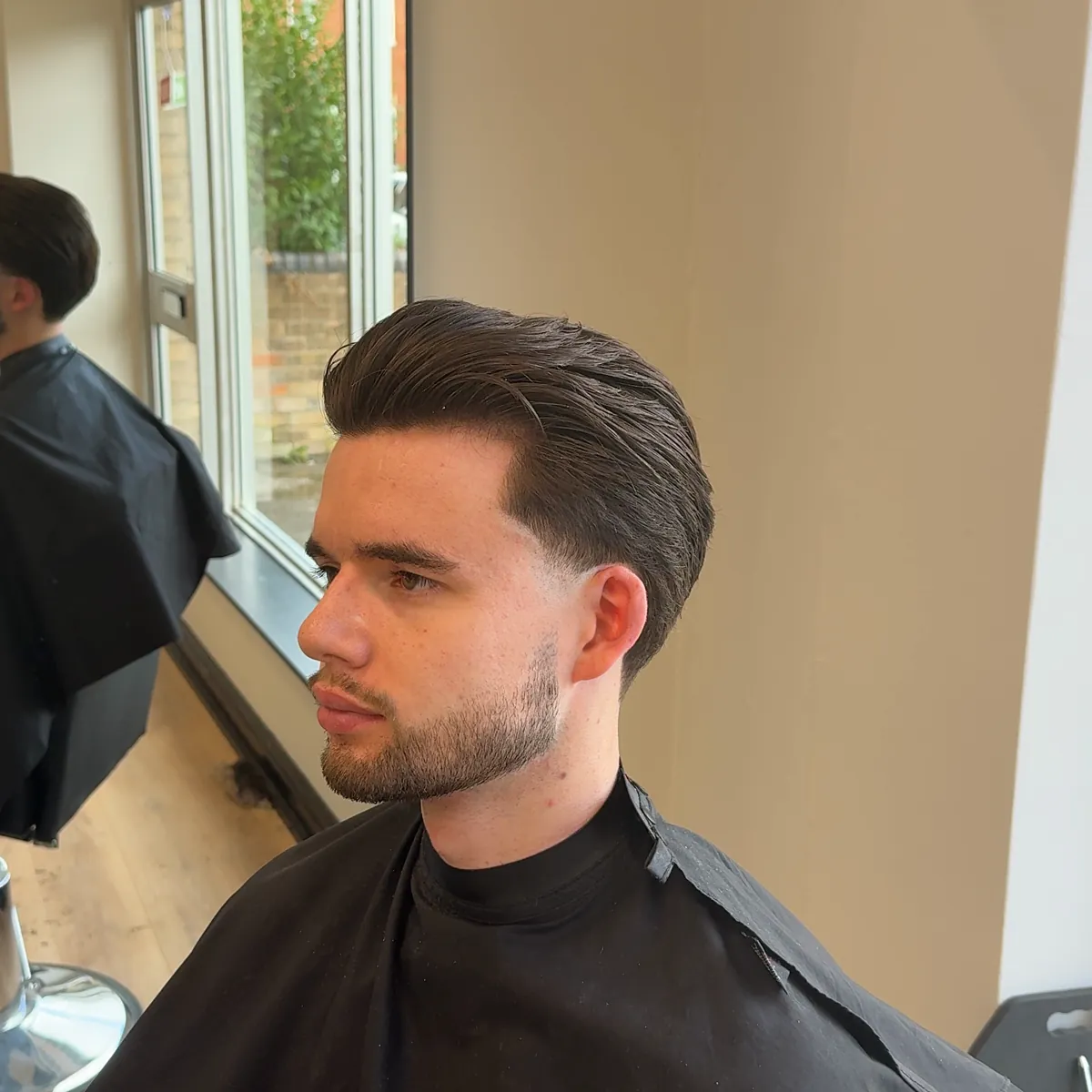 Textured pompadour with a tapered back and sides